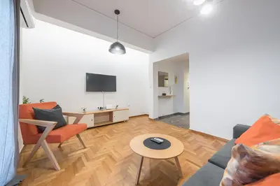 a living room with a couch and a table at Airy 1BR by Flisvos Marina in Athens