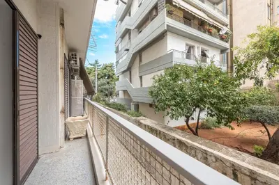 an empty balcony of a building with a tree at Airy 1BR by Flisvos Marina in Athens