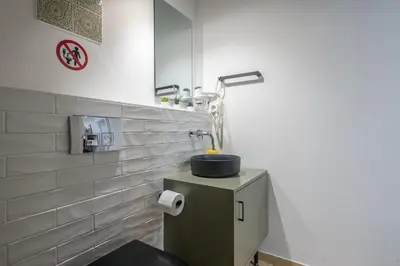 a bathroom with a sink and a mirror at Airy 1BR by Flisvos Marina in Athens