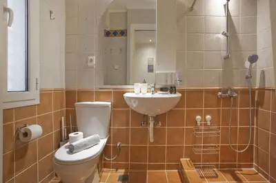 a bathroom with a toilet and a sink at Otto Centro in Athens