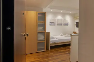 a small room with a bed and a closet at Otto Centro in Athens