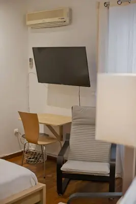 a room with a desk and a chair and a computer at Otto Centro in Athens