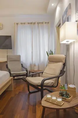 a living room with two chairs and a table at Otto Centro in Athens