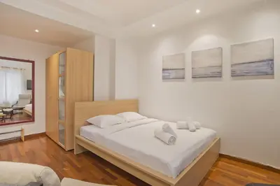 a bedroom with a bed with two towels on it at Otto Centro in Athens