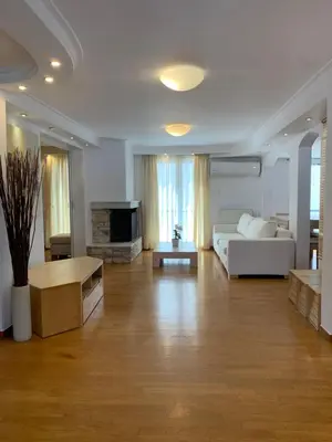 a living room with a white couch and a table at Dafni Athens loft in Athens