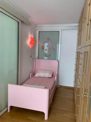 a bedroom with a pink bed in a room with windows at Dafni Athens loft in Athens