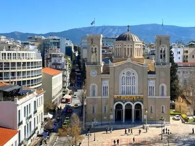 a large building in the middle of a city at Sophistic Athens in Athens