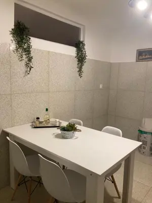 a white table and chairs in a room at Bella's apartment in Athens