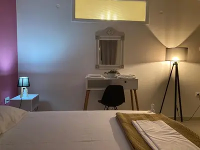 a bedroom with a bed and a desk and a mirror at Bella's apartment in Athens