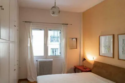 a bedroom with a bed and a window at Premium Plaka Apartment in Historic Athens City in Athens