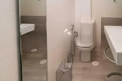 a bathroom with a toilet and a sink at Premium Plaka Apartment in Historic Athens City in Athens