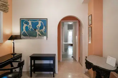 a room with a desk and a table and a painting at Premium Plaka Apartment in Historic Athens City in Athens