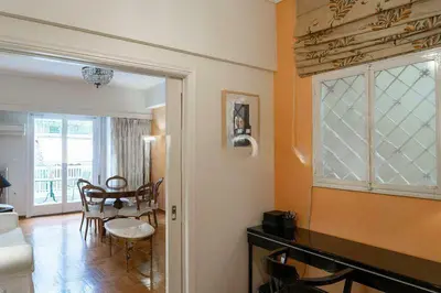 a living room with a dining table and a window at Premium Plaka Apartment in Historic Athens City in Athens