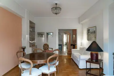 a living room with a table and chairs and a couch at Premium Plaka Apartment in Historic Athens City in Athens