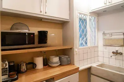 a kitchen with a counter with a microwave and a sink at Premium Plaka Apartment in Historic Athens City in Athens