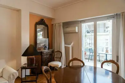 a living room with a table and a mirror at Premium Plaka Apartment in Historic Athens City in Athens