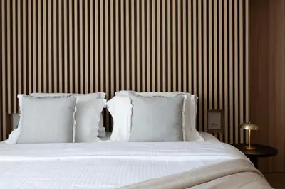 a bedroom with a bed with white sheets and pillows at 1BD SV Beach Condo with Pool in Athens