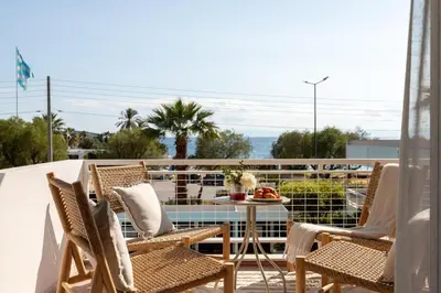 a patio with chairs and a table on a balcony at 1BD SV Beach Condo with Pool in Athens