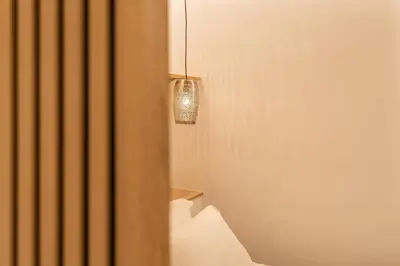 a room with a light hanging from a wall at Mini Sinatra Suite Syntagma in Athens