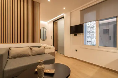 a living room with a couch and a table at Mini Sinatra Suite Syntagma in Athens