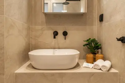 a bathroom with a large white bowl sink on a counter at Mini Sinatra Suite Syntagma in Athens