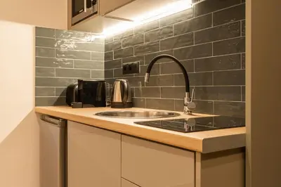 a kitchen with a sink and a counter top at Mini Sinatra Suite Syntagma in Athens