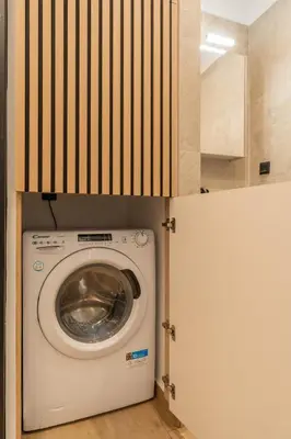 a washer and dryer in a laundry room with a door at Mini Sinatra Suite Syntagma in Athens