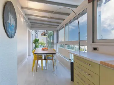 a kitchen with a small table and some windows at AthensView Bird's Eye Penthouse with Acropolis view -ONE BEDROOM FLAT in Athens