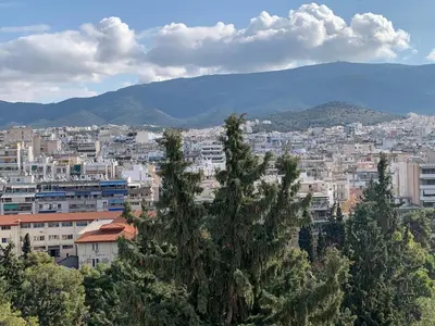 a view of a city with buildings and trees at AthensView Bird's Eye Penthouse with Acropolis view -ONE BEDROOM FLAT in Athens