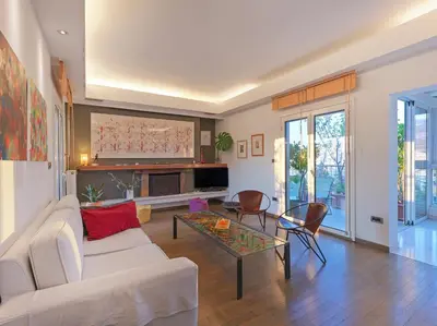 a living room with a white couch and a table at AthensView Bird's Eye Penthouse with Acropolis view -ONE BEDROOM FLAT in Athens