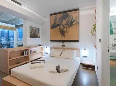 a bedroom with a large white bed with shoes on it at AthensView Bird's Eye Penthouse with Acropolis view -ONE BEDROOM FLAT in Athens