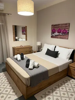 a bedroom with a large bed with towels on it at Nektaria philoxenia place in Athens