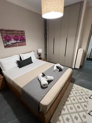 a bedroom with a large bed with towels on it at Nektaria philoxenia place in Athens