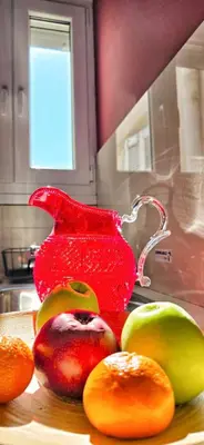 a group of fruit on a counter with a red pitcher at Cozy Near Acropolis by LV in Athens