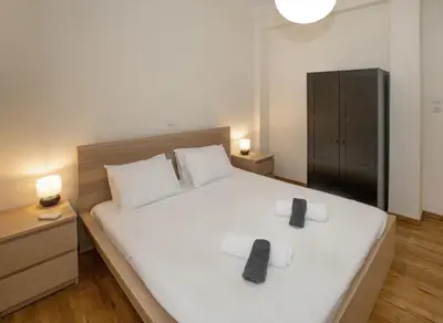 a bedroom with a large white bed with two towels at Modern Rental with Cozy Charm by GHH in Athens