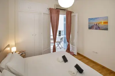 a bedroom with a white bed in a room at Modern Rental with Cozy Charm by GHH in Athens