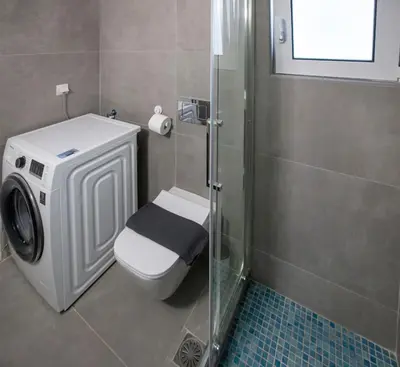 a bathroom with a toilet and a glass shower at Modern Rental with Cozy Charm by GHH in Athens