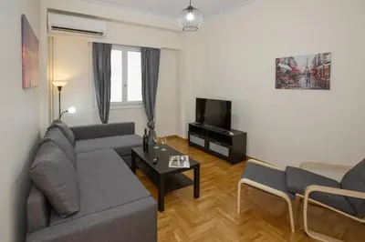 a living room with a couch and a tv at Modern Rental with Cozy Charm by GHH in Athens