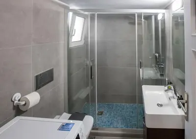 a bathroom with a shower and a toilet and a sink at Modern Rental with Cozy Charm by GHH in Athens