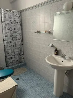 a bathroom with a sink and a shower at LoftLiving cozy in Athens