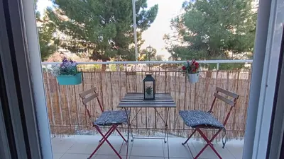 a patio table and chairs on a balcony with a view at Central Apartment Near Acropoli in Athens
