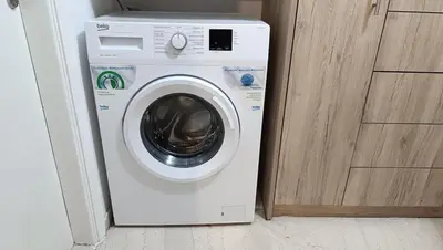 a white washing machine sitting next to a door at Central Apartment Near Acropoli in Athens