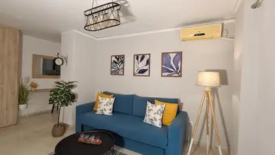 a living room with a blue couch with pillows at Central Apartment Near Acropoli in Athens