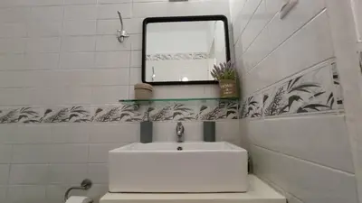 a white bathroom with a sink and a mirror at Central Apartment Near Acropoli in Athens