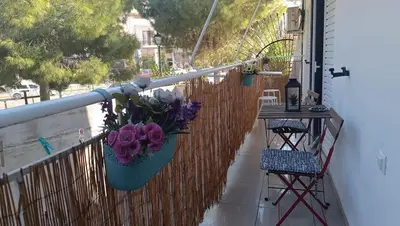 a balcony with a vase of flowers on a fence at Central Apartment Near Acropoli in Athens