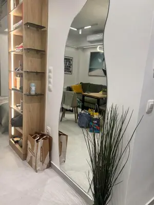 a mirror in a room with a living room at Stylish & Cozy 1 BR in Lycabetus in Athens