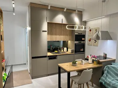 a kitchen with a wooden table and a counter top at Stylish & Cozy 1 BR in Lycabetus in Athens