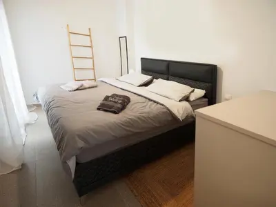 a bed with a black headboard in a room at The Gallery in Athens