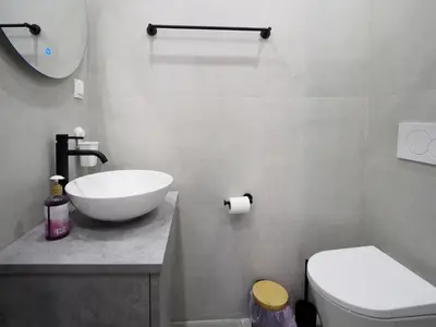 a bathroom with a white sink and a toilet at The Gallery in Athens