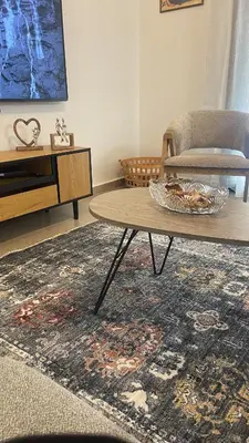 a living room with a coffee table and a chair at The Gallery in Athens